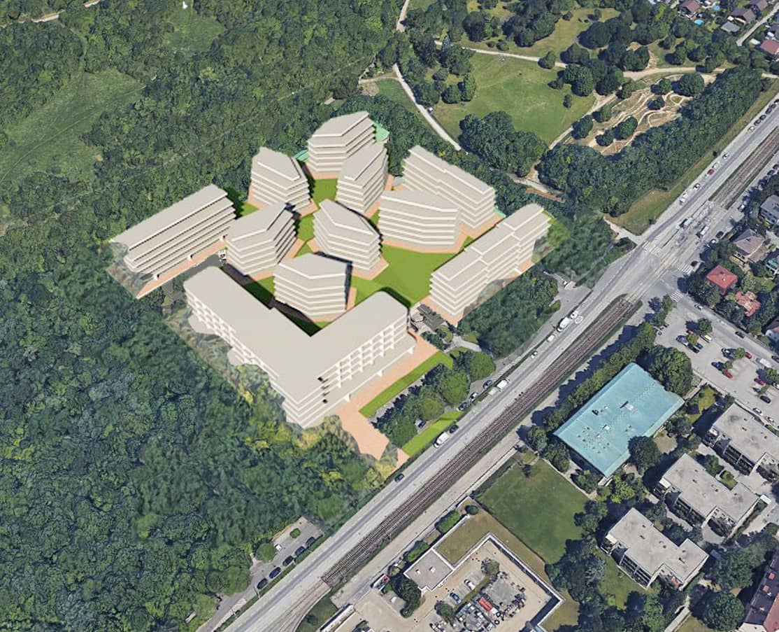3D-Architekturvisualisierung einer geplanten Wohnanlage aus der Vogelperspektive, eingebettet in ein grünes Wald- und Parkgebiet neben Bahngleisen.